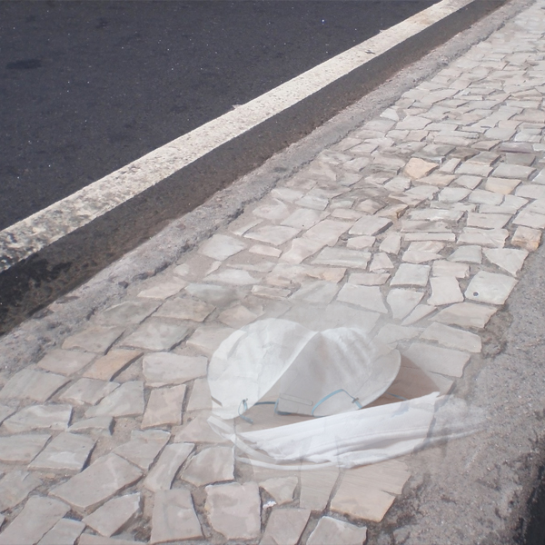 Masks lie on a cobblestone road that stretches into the distance. (Photos © FreeImages/Luiz Renato D. Coutinho and Coronavirus Stock)