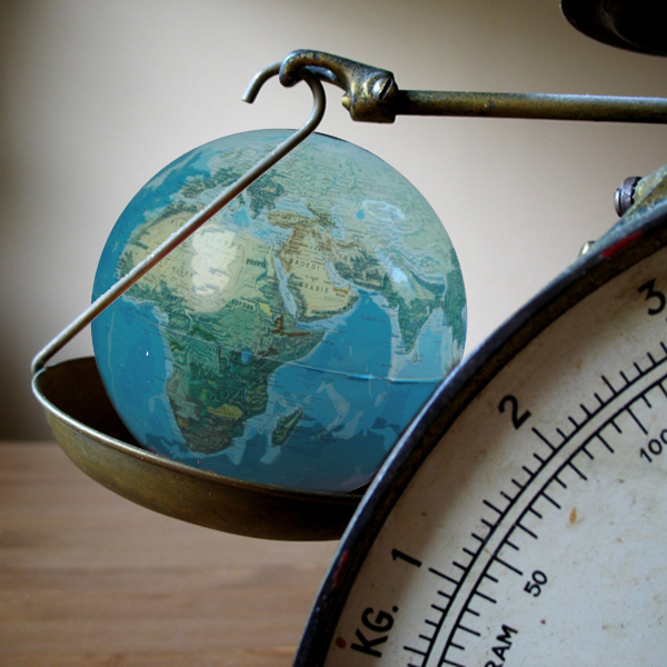 A scale weighs the Earth. (Photos © FreeImages/Pontus Edenberg and Edu Wagtelenberg)