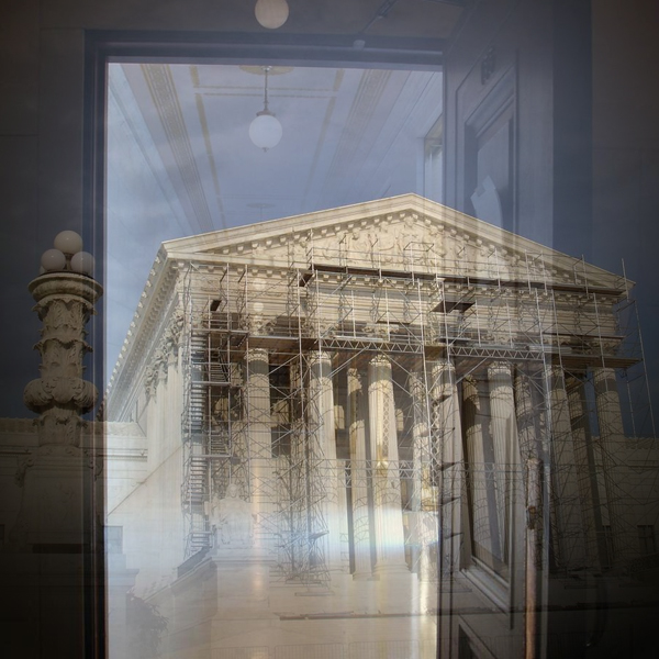 A door and hallway inside the U.S. Supreme Court leads back to the Court's exterior steps and pillars, which are scaffolded for repairs. (Photo © FreeImages/David Lat)