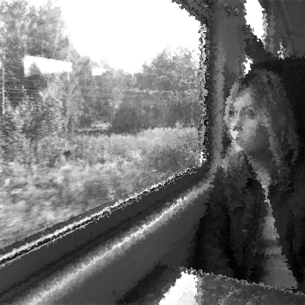 A black-and-white photo of a woman staring out the window of a train. (Photo © FreeImages/Andy1966)