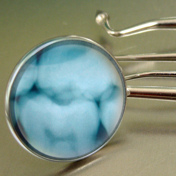 A dental mirror evaluates a set of teeth. (Photos © FreeImages/qr5 and plex)