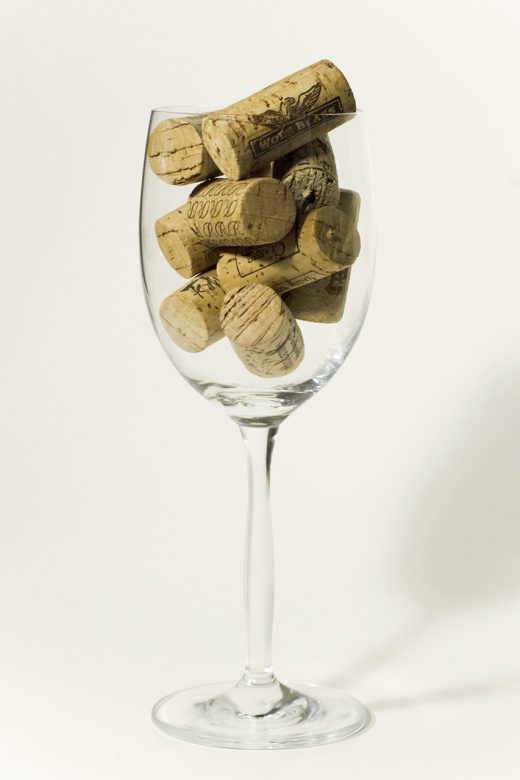 A champagne glass filled with corks. (TopShelf-FreeImages)